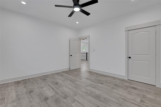 unfurnished room with ceiling fan and light wood-type flooring