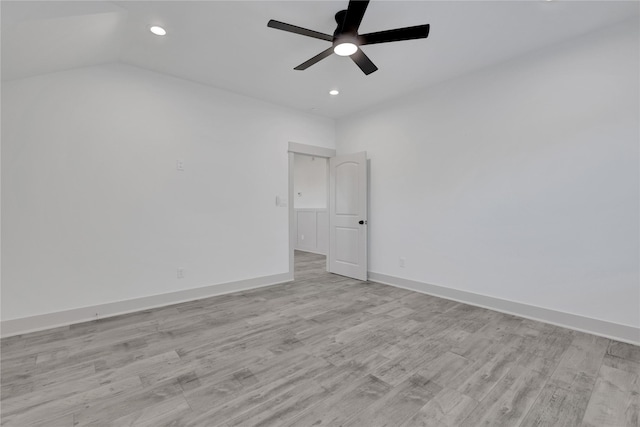 spare room with ceiling fan, light hardwood / wood-style flooring, and lofted ceiling