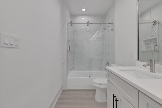 full bathroom featuring vanity, toilet, wood-type flooring, and enclosed tub / shower combo