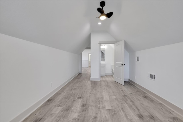 additional living space featuring ceiling fan, light hardwood / wood-style flooring, and vaulted ceiling