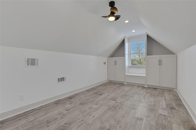 additional living space with light hardwood / wood-style floors, ceiling fan, and lofted ceiling