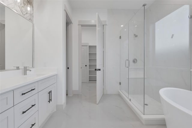 bathroom with vanity and independent shower and bath