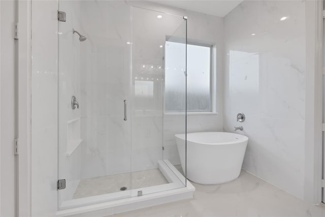 bathroom featuring separate shower and tub