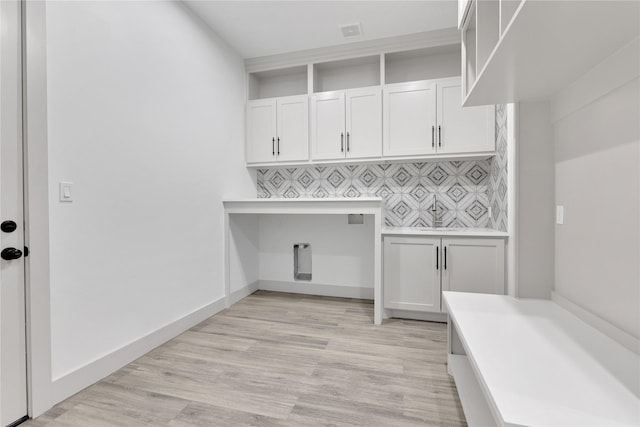 washroom with cabinets and light wood-type flooring