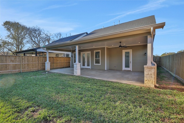 rear view of property with ceiling fan, a yard, a patio, and french doors