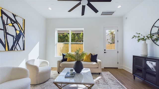 living room featuring recessed lighting, a healthy amount of sunlight, visible vents, and wood finished floors