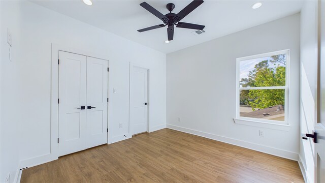 unfurnished bedroom featuring light wood-type flooring and ceiling fan