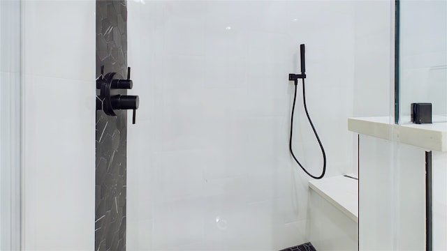 interior details featuring a tile shower