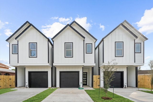 modern inspired farmhouse with a front lawn and a garage