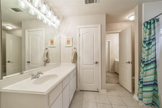 bathroom with tile patterned floors, vanity, and a shower with shower curtain