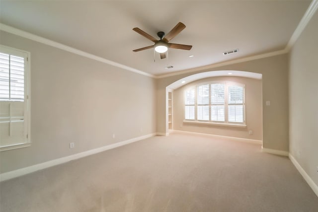 unfurnished room with carpet flooring, ceiling fan, and crown molding