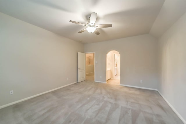 unfurnished bedroom featuring ceiling fan, lofted ceiling, and light carpet