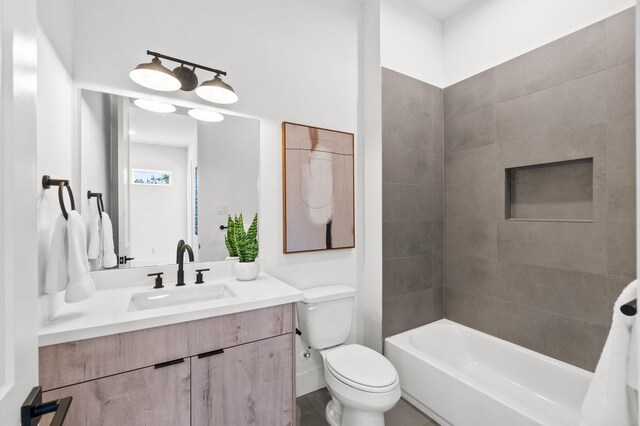 full bathroom featuring shower / bath combination, vanity, baseboards, and toilet
