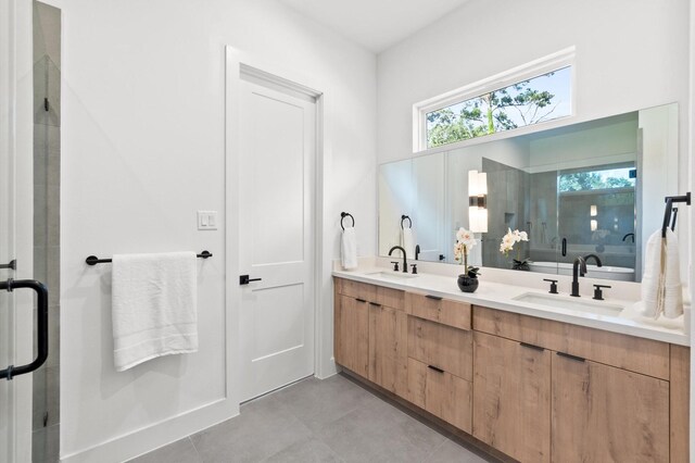 bathroom featuring vanity and a shower with door