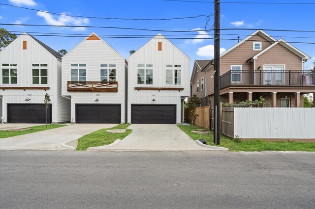 view of front of home with a balcony and a garage