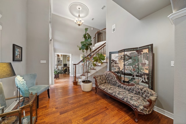 entrance foyer featuring hardwood / wood-style floors and a notable chandelier