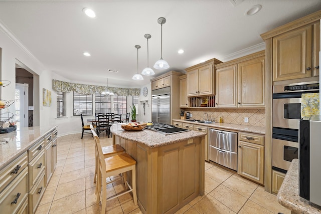 kitchen with light stone counters, a center island, appliances with stainless steel finishes, pendant lighting, and backsplash