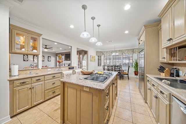 kitchen featuring a kitchen island, appliances with stainless steel finishes, pendant lighting, sink, and kitchen peninsula