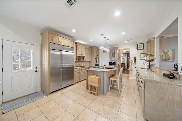 kitchen featuring a kitchen breakfast bar, light stone counters, kitchen peninsula, stainless steel appliances, and crown molding