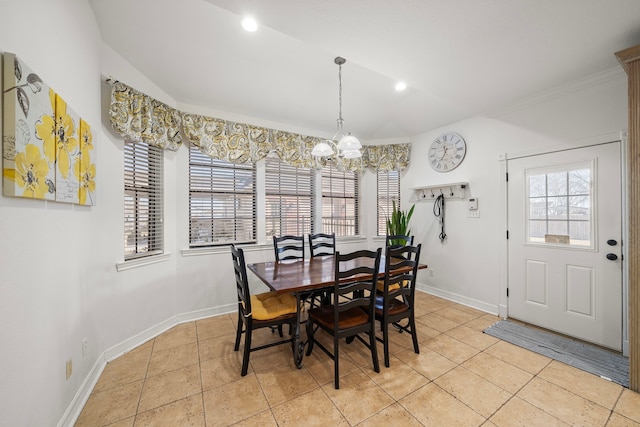 dining room with light tile patterned flooring, ornamental molding, and a chandelier