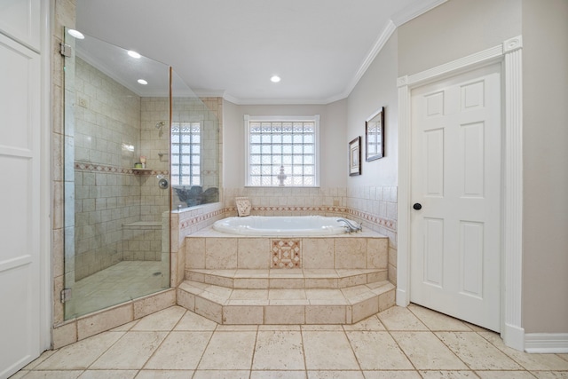 bathroom featuring ornamental molding and separate shower and tub