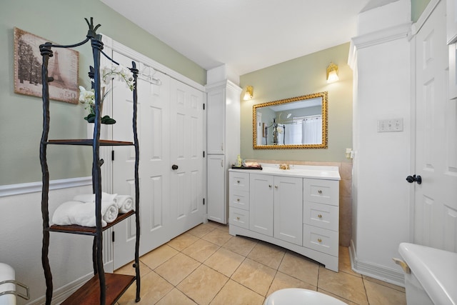 bathroom with walk in shower, vanity, and tile patterned flooring