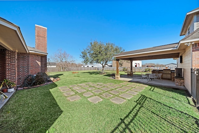 view of yard with area for grilling and a patio