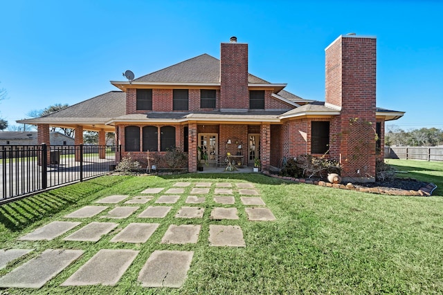 rear view of house with a yard and a patio area