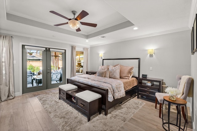 bedroom with access to exterior, ceiling fan, french doors, a raised ceiling, and ornamental molding