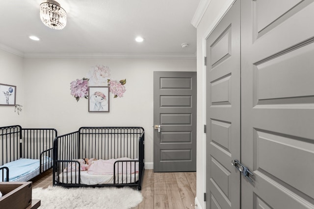 bedroom with ornamental molding and light wood-type flooring