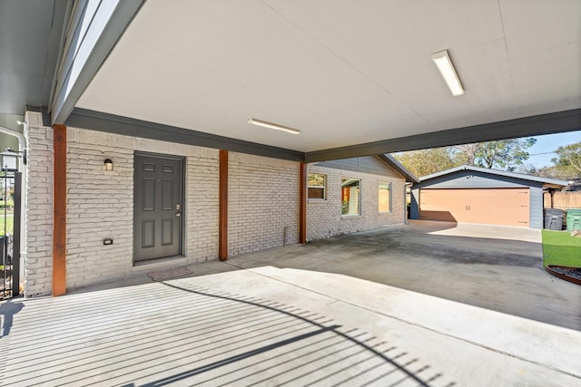 view of patio / terrace with a garage and an outdoor structure