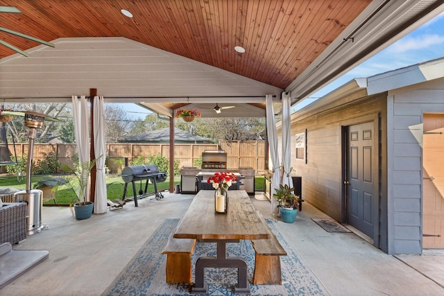 view of patio featuring area for grilling, ceiling fan, and exterior kitchen