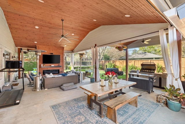 view of patio / terrace featuring an outdoor living space with a fireplace, ceiling fan, and grilling area