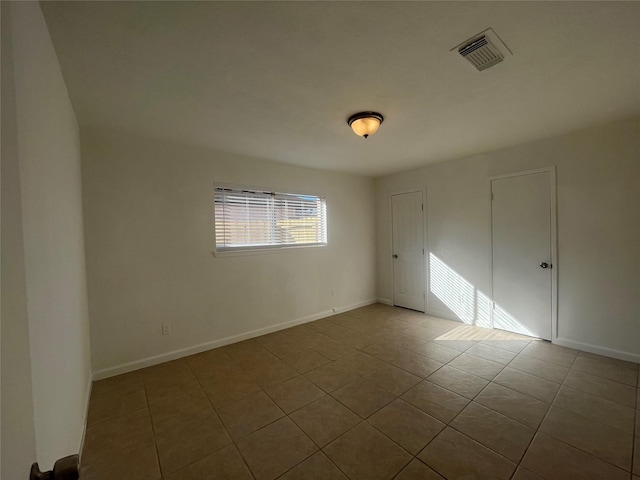 spare room with light tile patterned floors