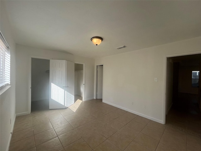 empty room with light tile patterned floors