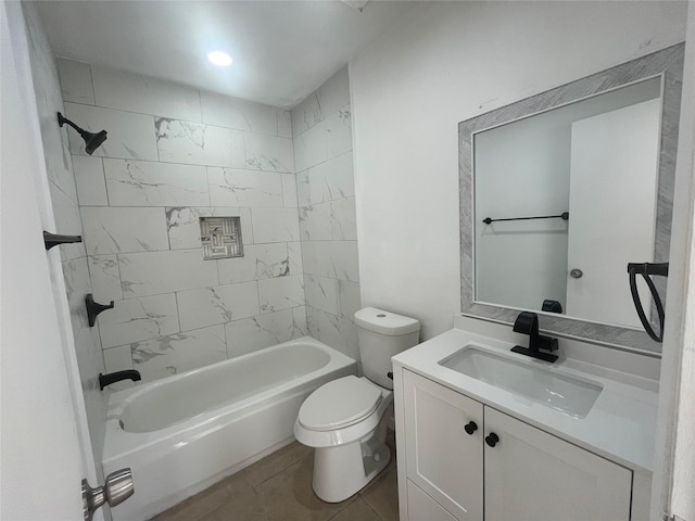 full bathroom featuring tile patterned floors, toilet, vanity, and tiled shower / bath