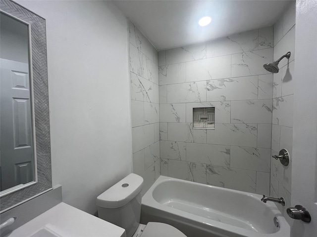 full bathroom featuring toilet, vanity, and tiled shower / bath