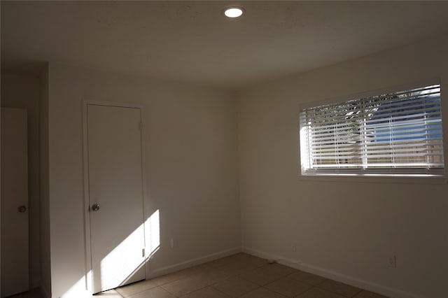 spare room with light tile patterned floors