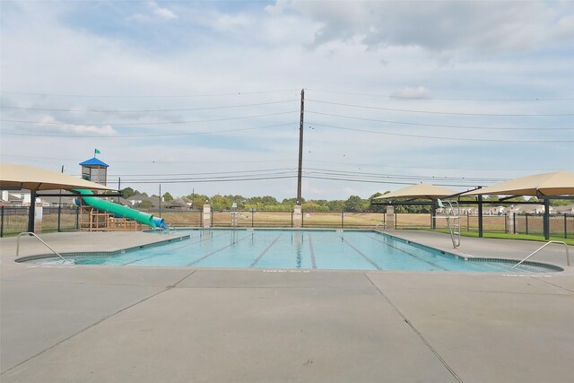 view of swimming pool featuring a playground and a gazebo