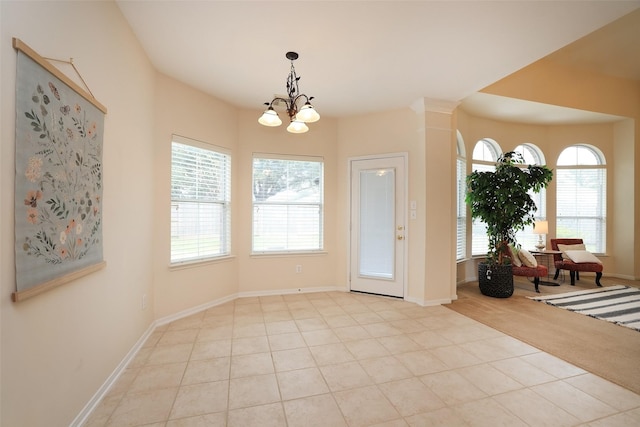 entryway featuring light tile patterned floors and a notable chandelier