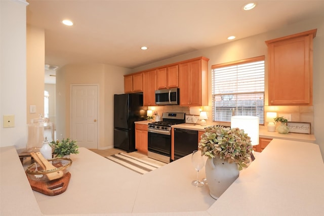 kitchen featuring black appliances and tasteful backsplash