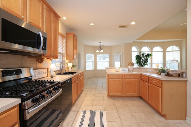 kitchen featuring pendant lighting, sink, an inviting chandelier, light tile patterned flooring, and stainless steel appliances