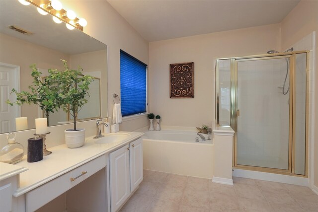 bathroom featuring separate shower and tub, vanity, and tile patterned flooring