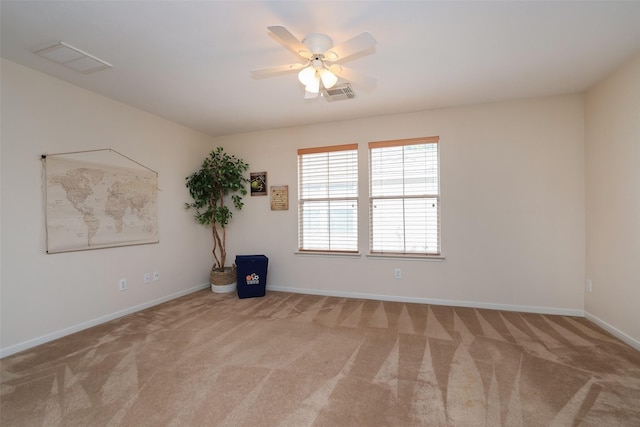 carpeted spare room with ceiling fan