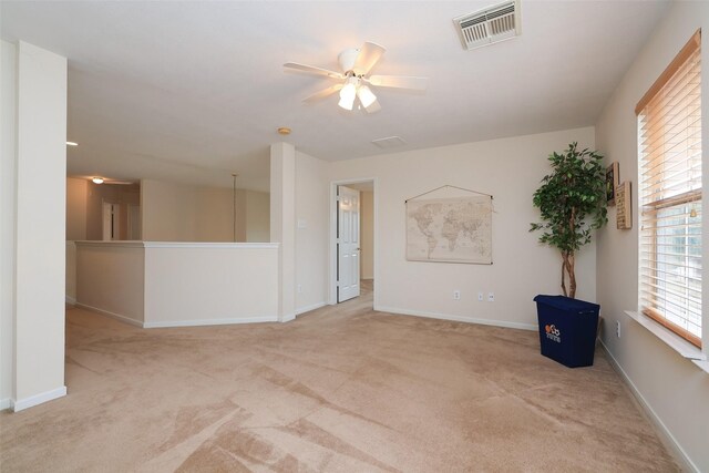 carpeted spare room with ceiling fan and a healthy amount of sunlight