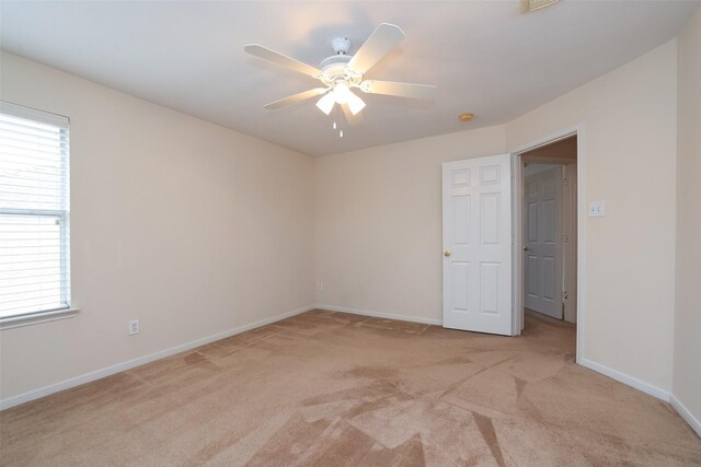 unfurnished room with ceiling fan and light colored carpet