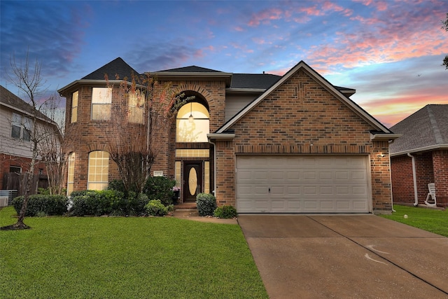 view of front of house with a garage and a yard