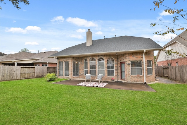 back of property with a lawn and a patio