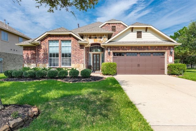 view of front of house featuring a garage and a front lawn