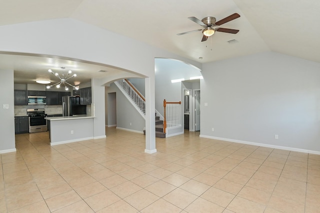 unfurnished living room with ceiling fan with notable chandelier, lofted ceiling, and light tile patterned floors